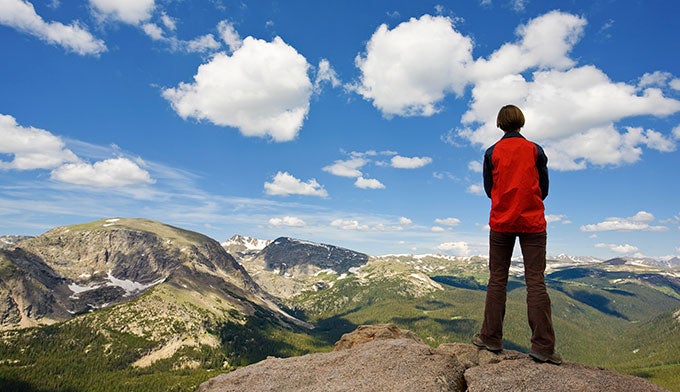 "Woman looking over the tundra at Rocky Mountain National Park"
