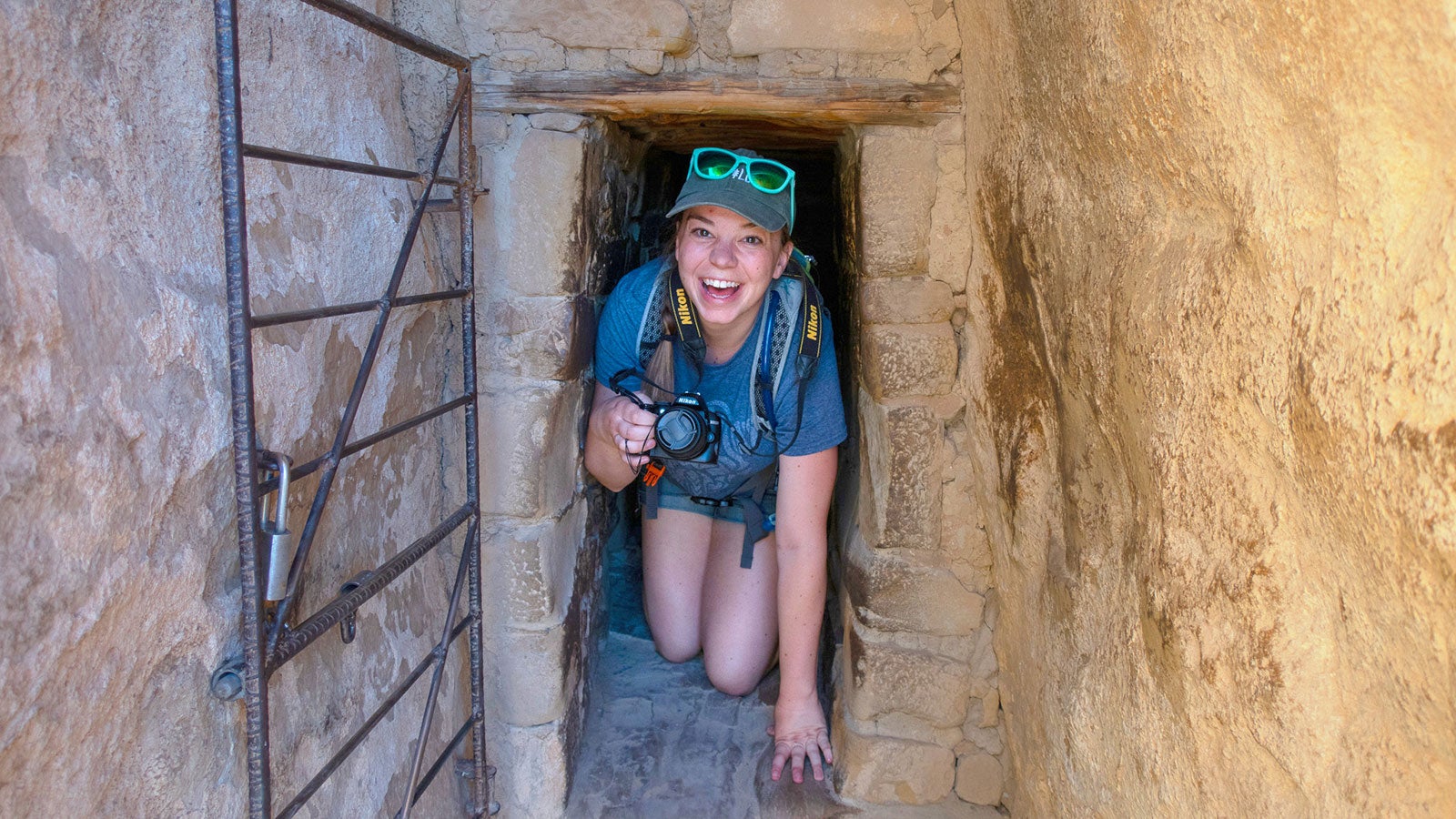 Author Mikaela Ruland crawling through the 12 ft. long, 18" wide tunnel at Balcony House
