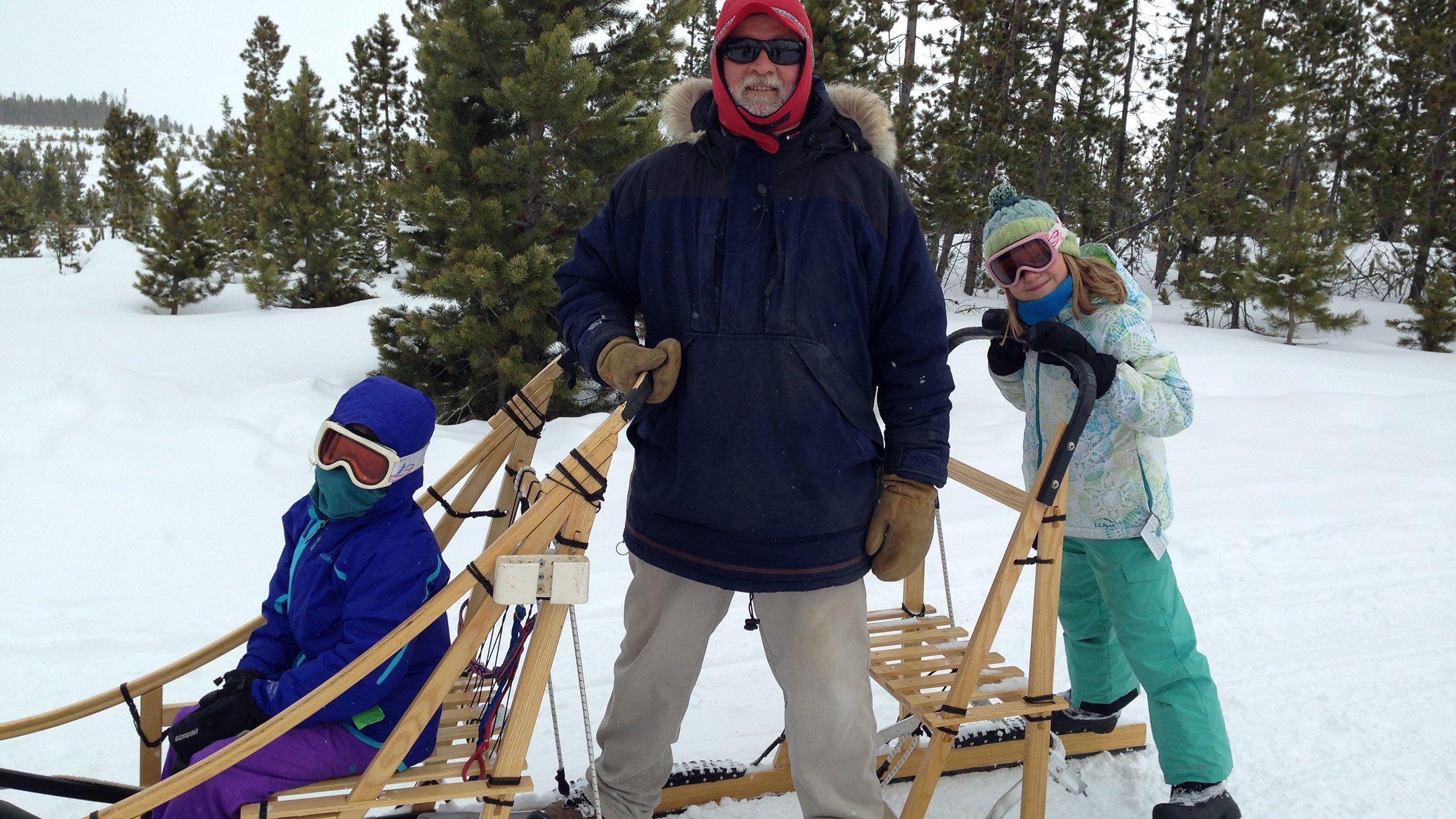 Kids with Steve Peterson on a dog sled at Snow Mountain Ranch, YMCA of the Rockies