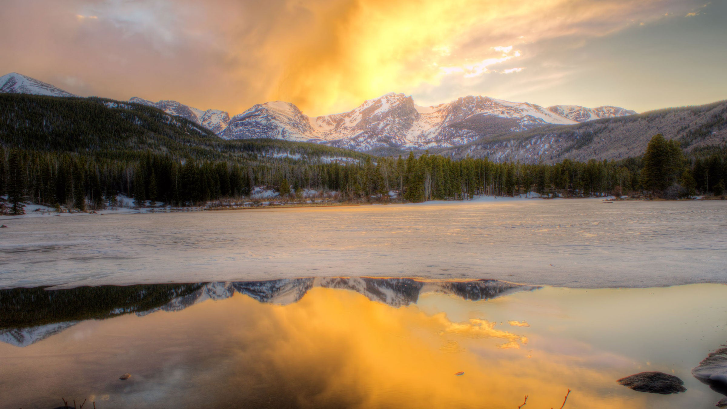 Sunrise at a frozen Sprague Lake in Rocky Mountain National Park